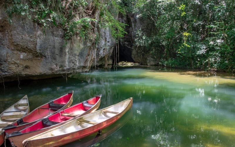 Cayo District, Belize - June 2018: Canoes at the entrance to Barton Creek Cave in the Cayo District of Belize, Central America. The cave, near San Ignacio, is an important Mayan archaeological site.